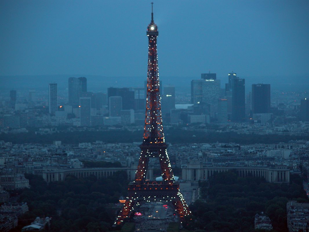 Paris 07 Lights On Eiffel Tower Just After Sunset With La Defense Behind From Montparnasse Tower 